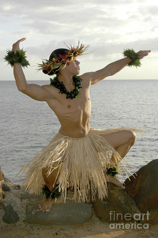 Male Hula Dancer poses on the beach in a traditional sun worship move. Photograph by Gunther Allen