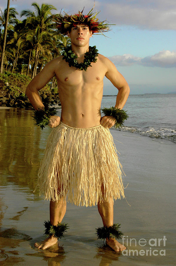 Male hula dancer poses with a power move at sunset by the beach. Photograph by Gunther Allen