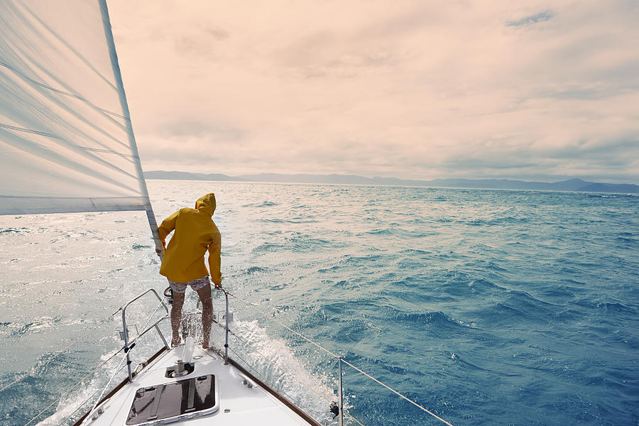 Male on sailing yacht, Whitsundays Photograph by Stuart Ashley