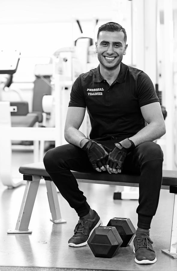 Male Personal Trainer Posing In Gym Photograph by Lorado