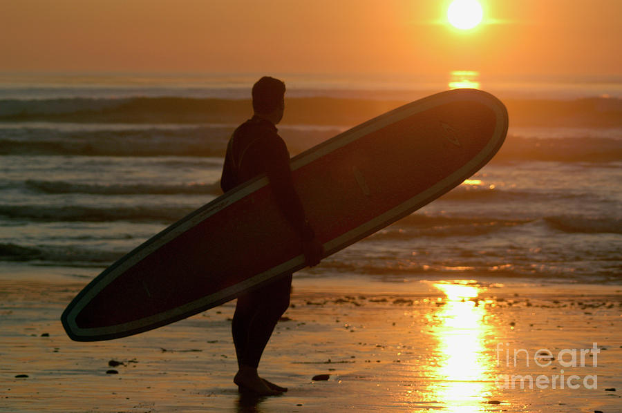 Male Surfer looking out at the waves at sunset  Photograph by Gunther Allen