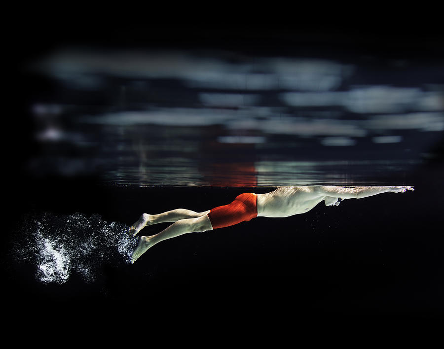 Male swimmer at the water surface Photograph by Henrik Sorensen