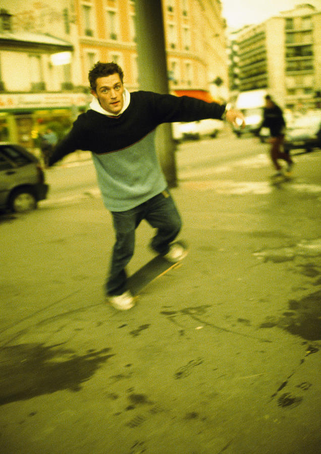 Male teenager on skateboard, blurred Photograph by Patrick Sheandell OCarroll