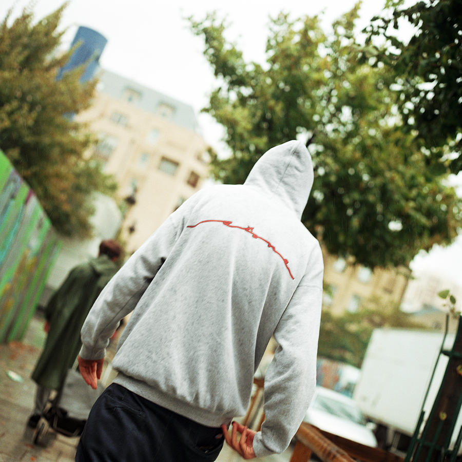 Male teenager with hood, rear view Photograph by Patrick Sheandell OCarroll