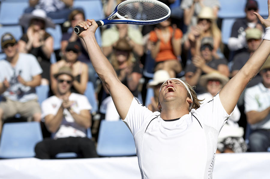 Male tennis player celebrating victory by crowd Photograph by Marc Debnam