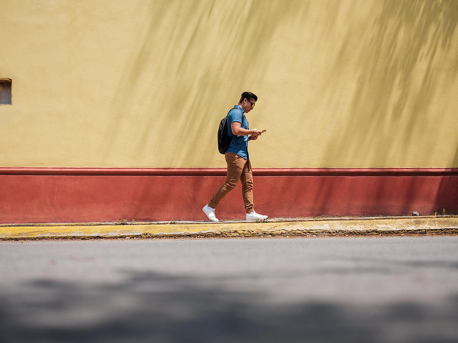 Male walking on the side walk Photograph by Aldomurillo
