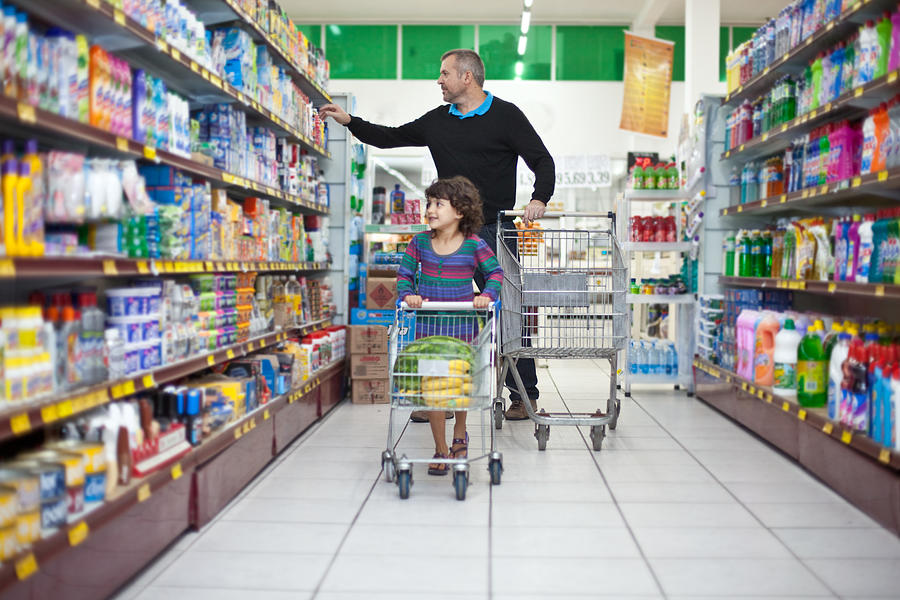Man and child shopping at supermarket Photograph by Paul Mansfield Photography