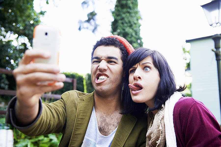 Man And Woman Making Funny Faces For Selfie Photograph by Tara Moore