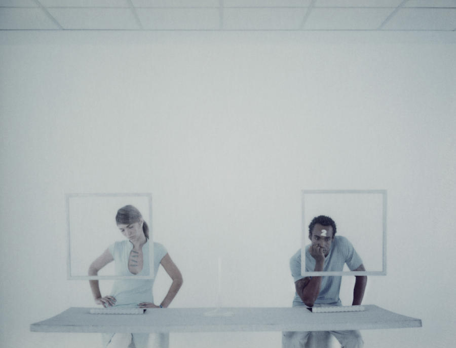 Man and woman sitting at desk Photograph by Matthieu Spohn
