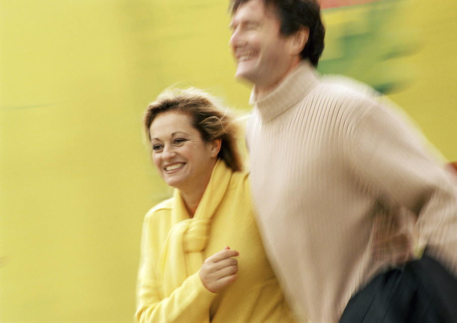 Man and woman walking together, blurred Photograph by Eric Audras