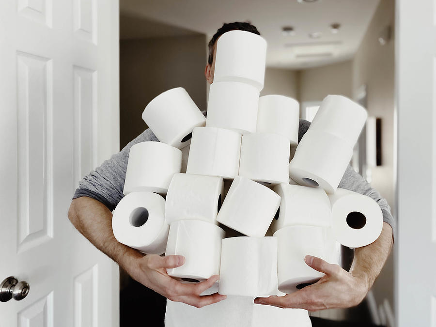 Man Carries Heap of Toilet Paper Photograph by Grace Cary