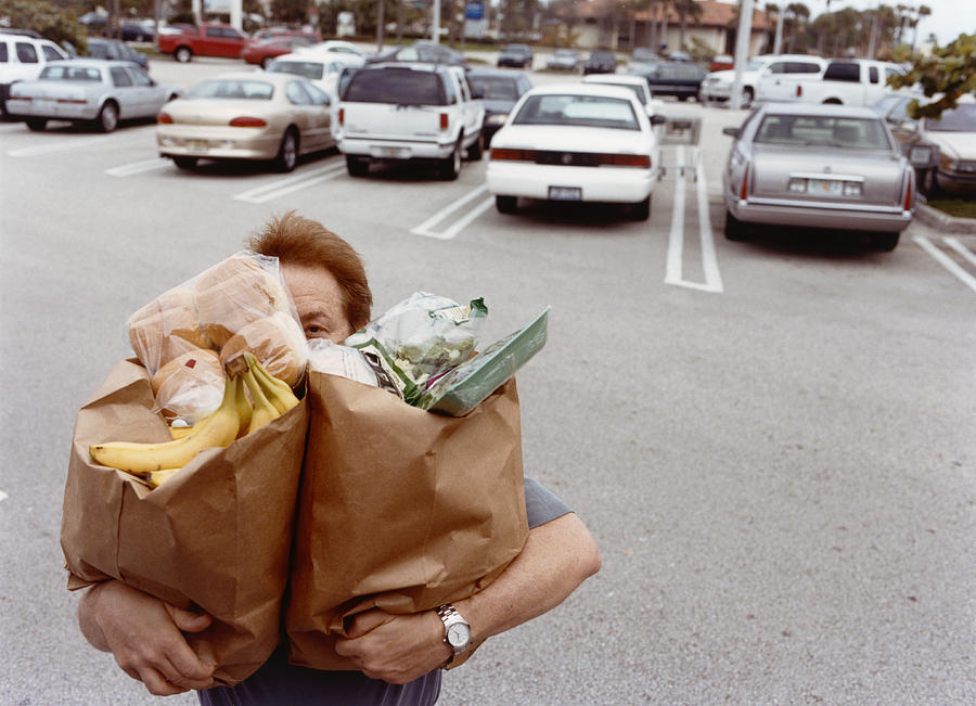 Man Carrying Grocery Bags Photograph by HollenderX2