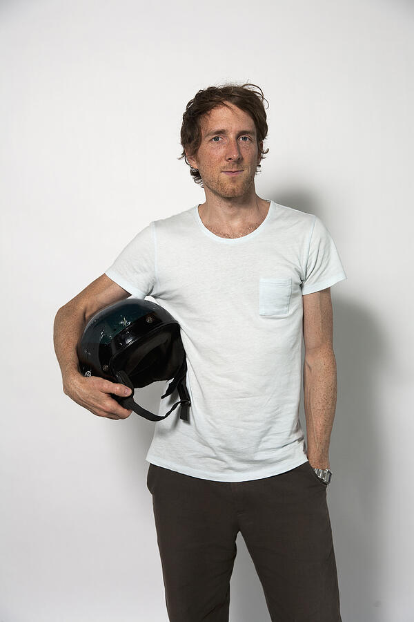 Man carrying helmet against white background Photograph by Westend61
