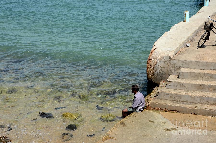 Man Dips Feet In Water At Beach Pier Near Steps In Jaffna Sri Lanka Photograph