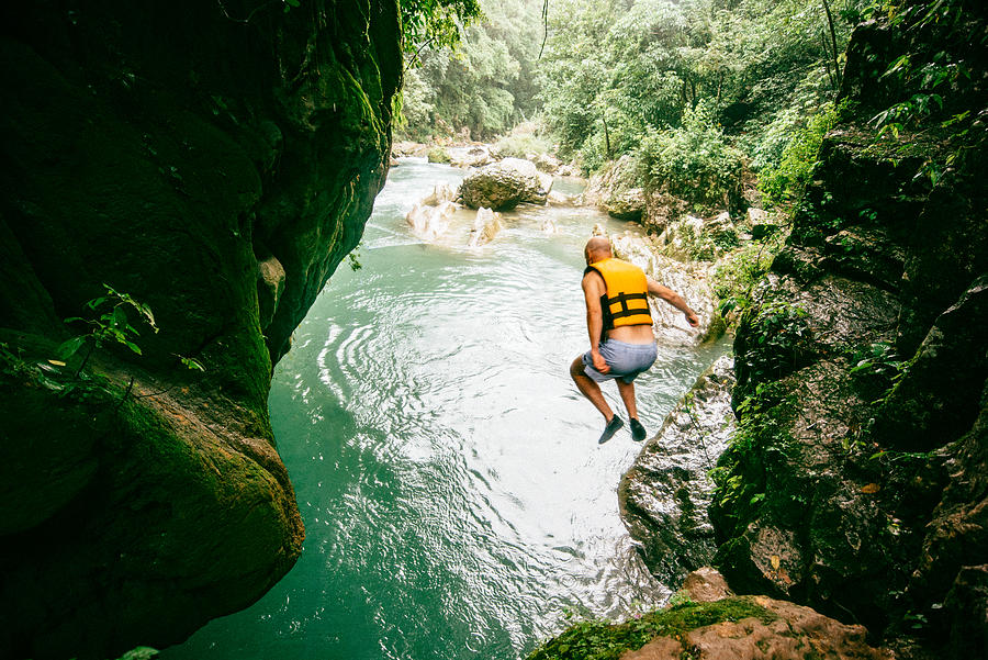 Man diving into river at Puente de Dios in San Luis Potosí Photograph by Ferrantraite