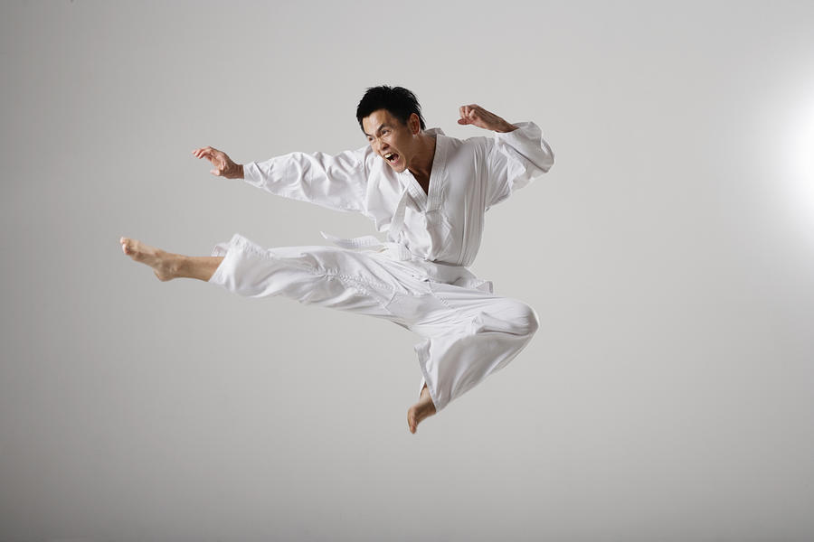 Man doing a flying kick, martial arts Photograph by Asia Images