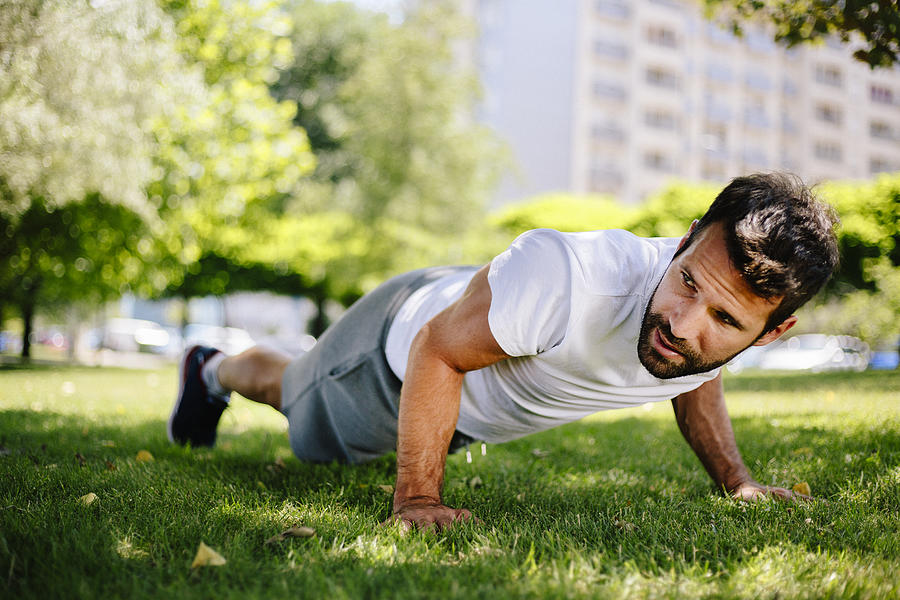 Man doing pushups in nature Photograph by Milanvirijevic