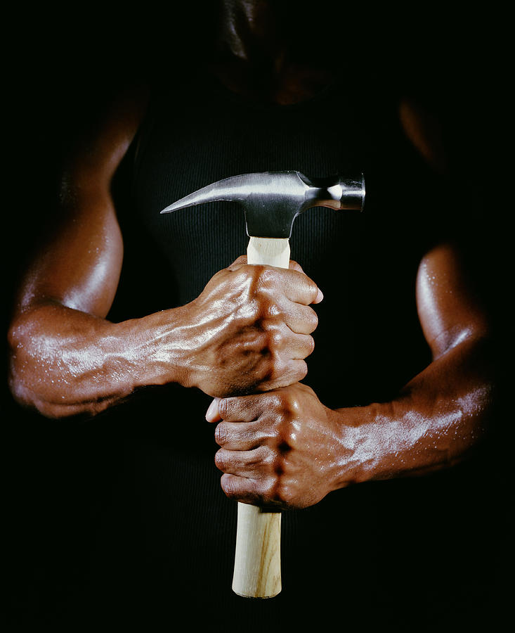 Man grasping a hammer, mid section Photograph by Ryan McVay