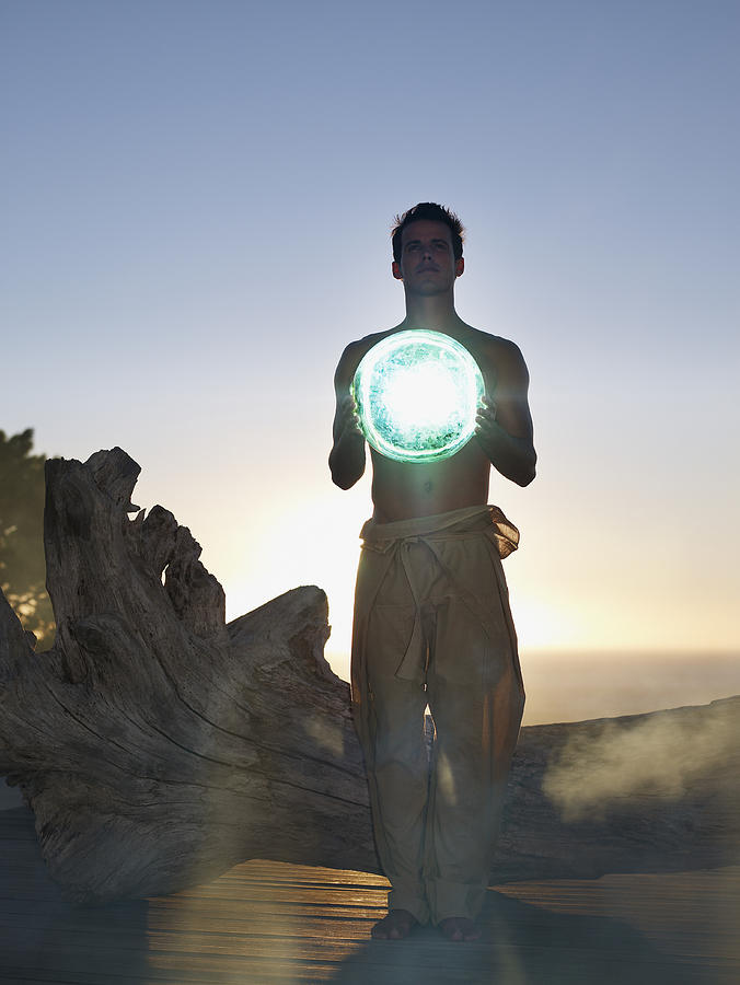 Man holding an orb Photograph by OJO Images