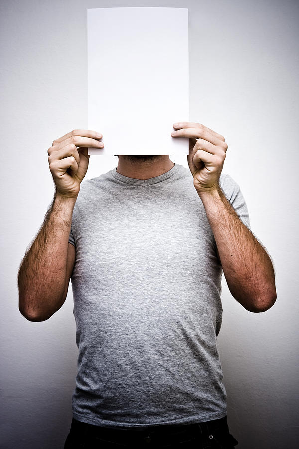 Man Holding Blank Sheet Paper in Front of Face Photograph by MoreISO