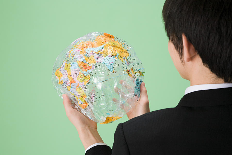 Man holding deflated globe Photograph by Image Source