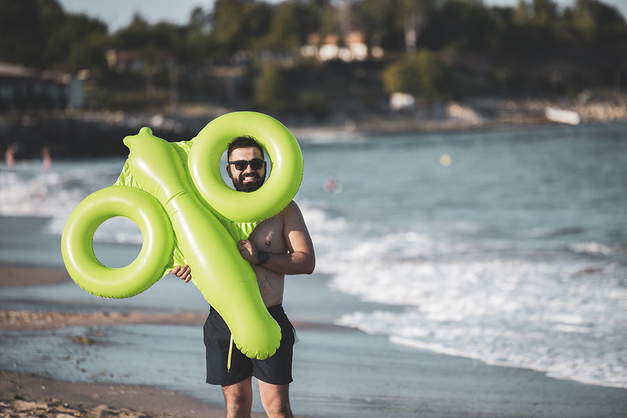 Man holding inflatable toy Photograph by ArtistGNDphotography
