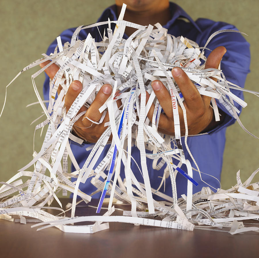 Man holding paper shreds Photograph by Burke/Triolo Productions