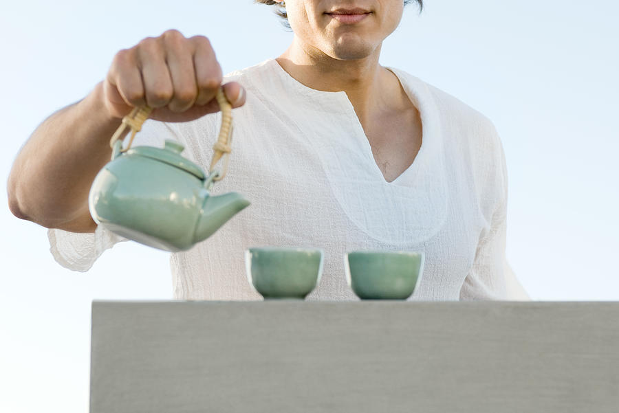 Man holding teapot, cropped, mid section Photograph by ZenShui/Michele Constantini