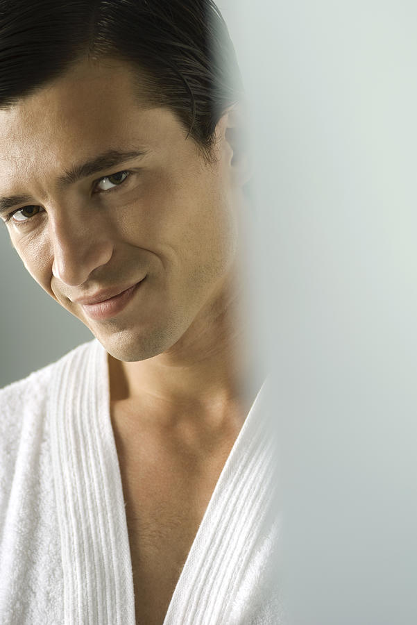 Man in bathrobe smiling at camera, portrait, cropped Photograph by PhotoAlto/Michele Constantini