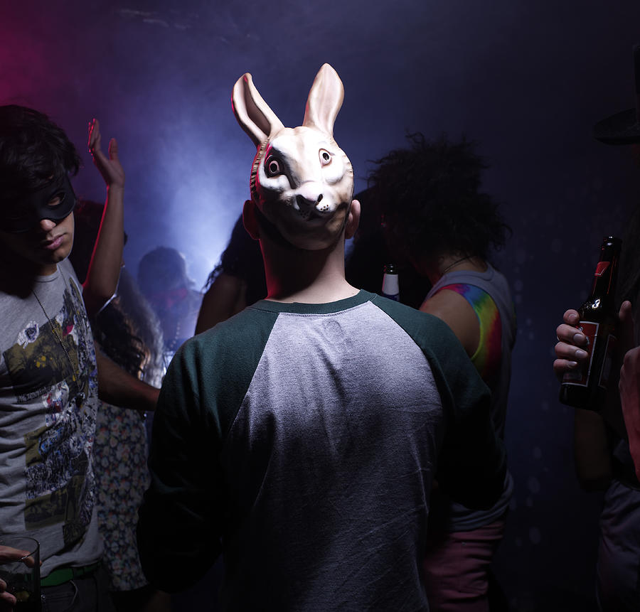 Man in bunny mask dancing in night club Photograph by Michael Blann