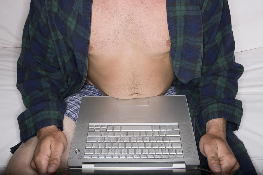 Man in his underwear using a laptop on the couch Photograph by Sian Kennedy
