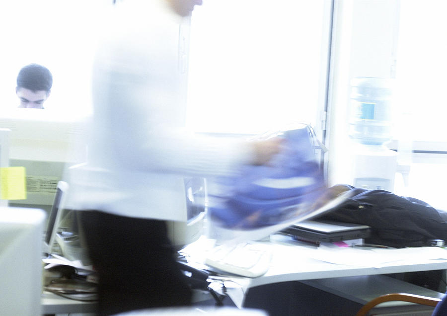 Man  in office walking, blurred motion Photograph by Isabelle Rozenbaum