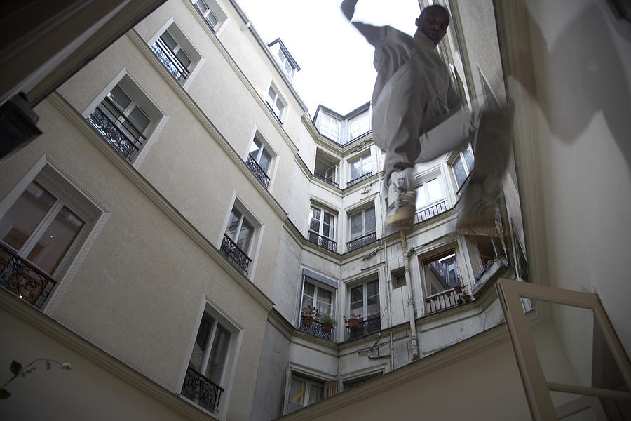 Man jumping off wall, low angle view Photograph by Matt Henry Gunther
