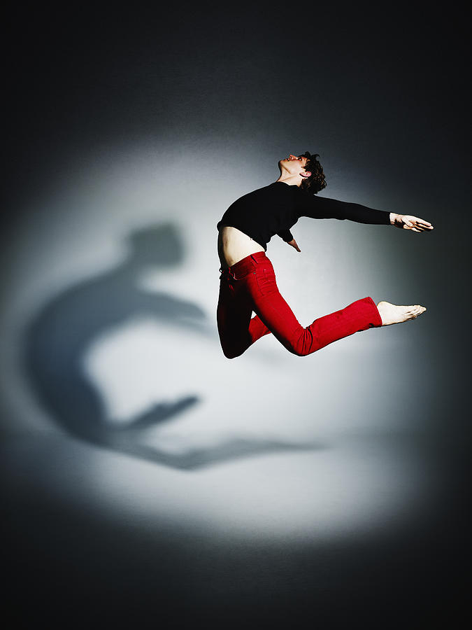Man jumping with arms and legs outstretched Photograph by Thomas Barwick