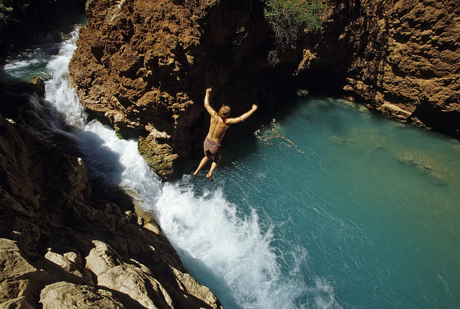 Man jumps into water in Grand Canyon Photograph by Whit Richardson