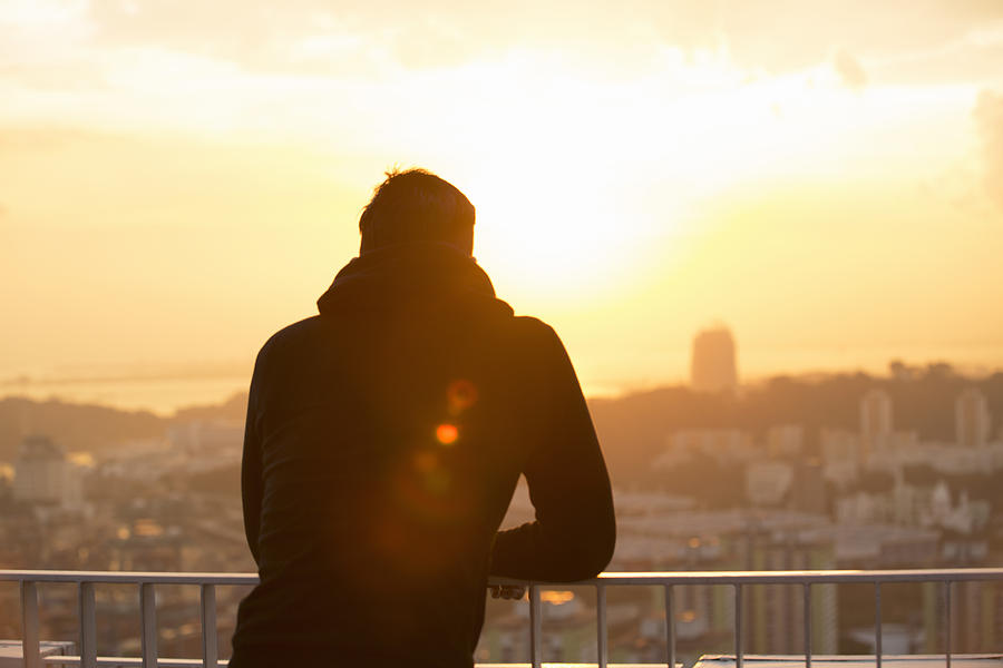 Man looking out over city at sunset Photograph by Eternity in an Instant