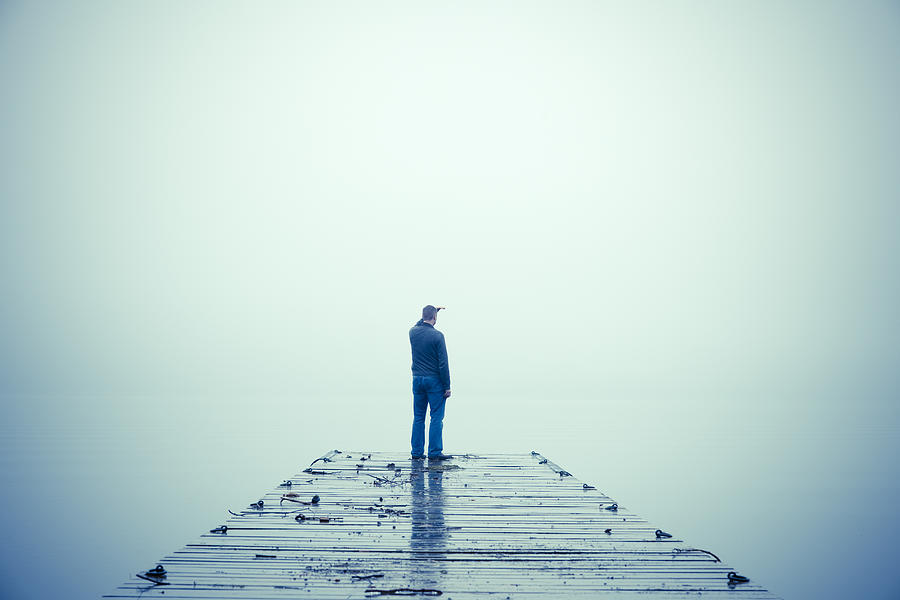Man Looking Out Through Fog and Standing on Dock Photograph by Creacart