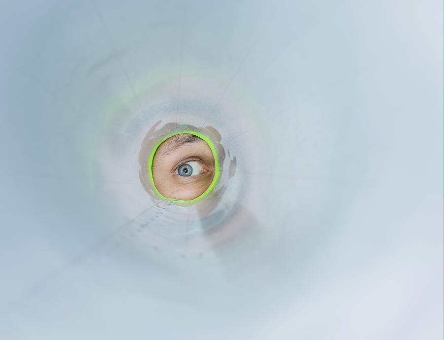 Man looks through a cardboard tube Photograph by Ozgurdonmaz
