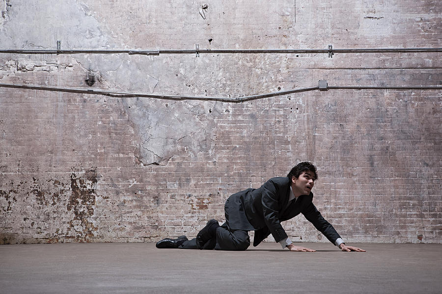 Man lying on warehouse floor Photograph by Image Source