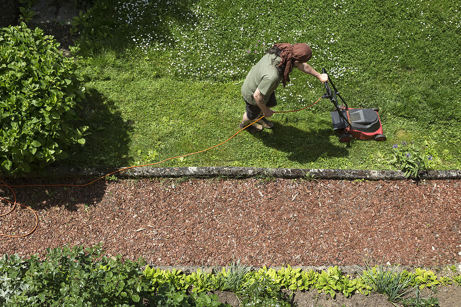 Man mowing the lawn Photograph by Westend61