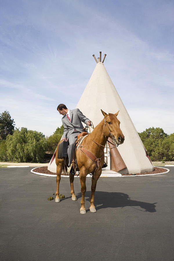 Man on horse in front of tepee-shaped motel unit. Photograph by David Zaitz