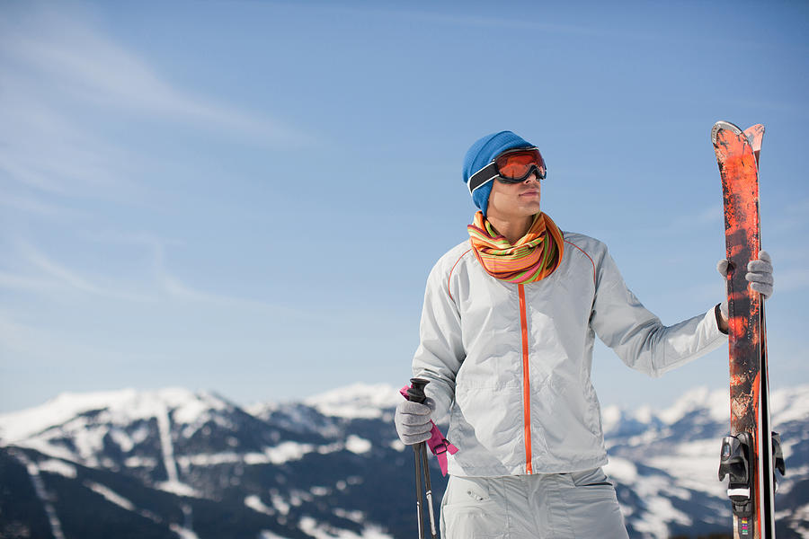 Man on mountain holding skis Photograph by Sam Edwards