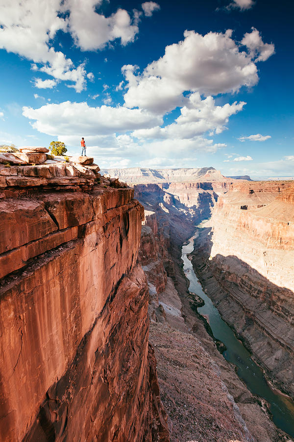 Man on the edge of overlook on Grand Canyon, USA Photograph by Matteo Colombo