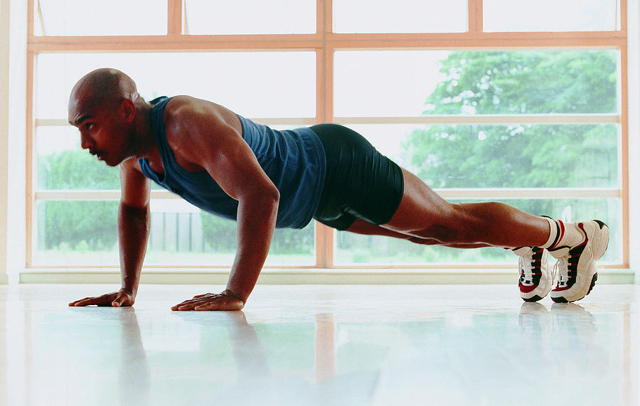 Man performing push-ups Photograph by Stockbyte