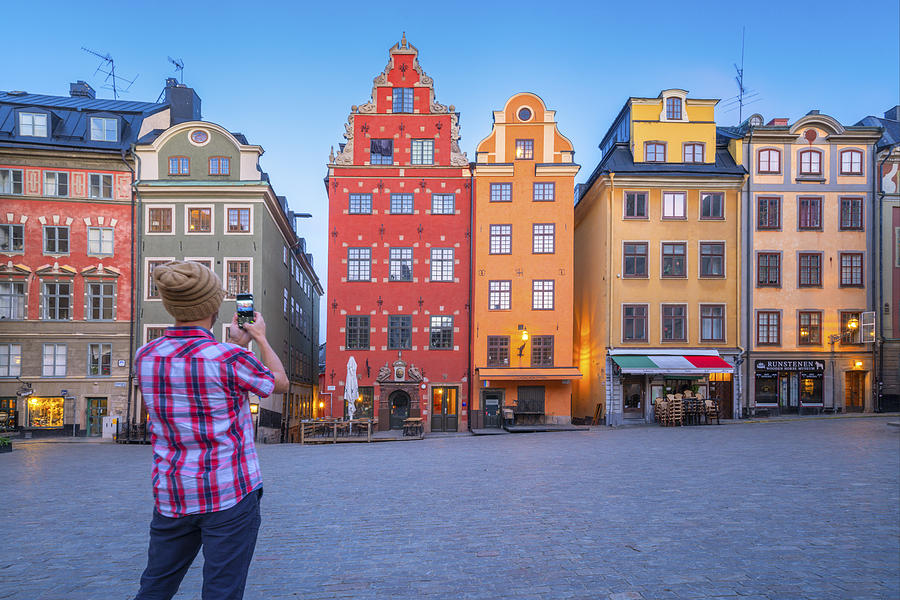Man photographing Stortorget Square, Gamla Stan, Stockholm Photograph by Roberto Moiola / Sysaworld