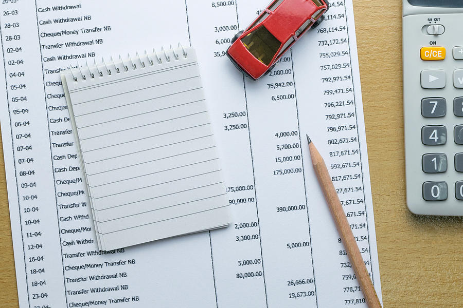 Man planning monthly budget, Finance about car concept Photograph by Zenstock