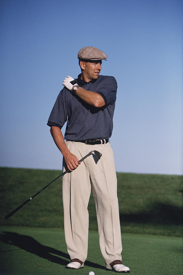 Man playing golf Photograph by Comstock