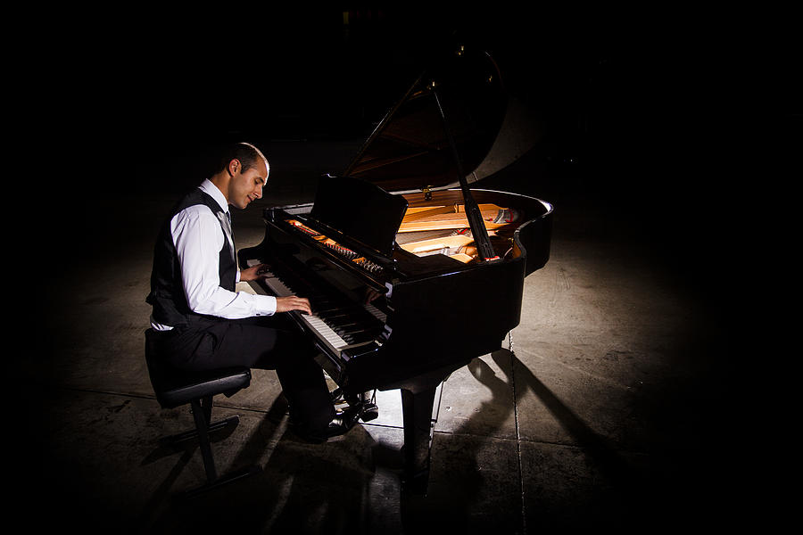 Man Playing Piano with Dramatic Lighting Photograph by Adamkaz