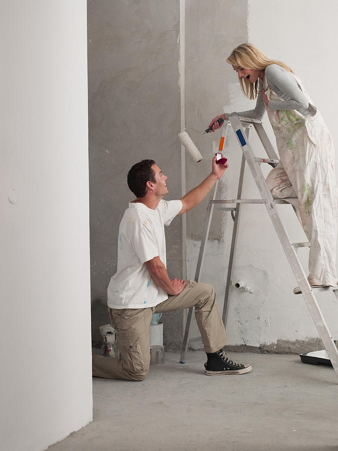 Man proposing to woman painting wall Photograph by Martin Barraud
