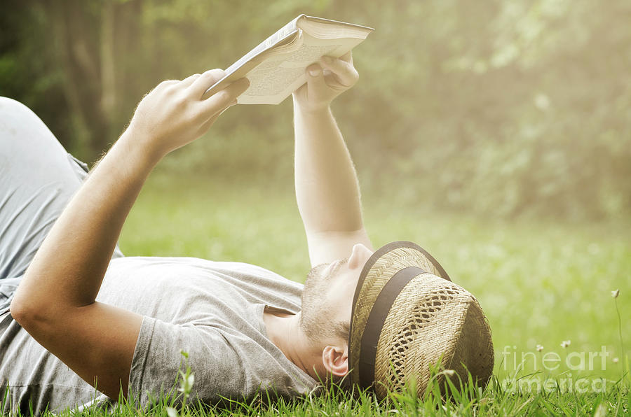 Man reading book in the park Photograph by Jelena Jovanovic